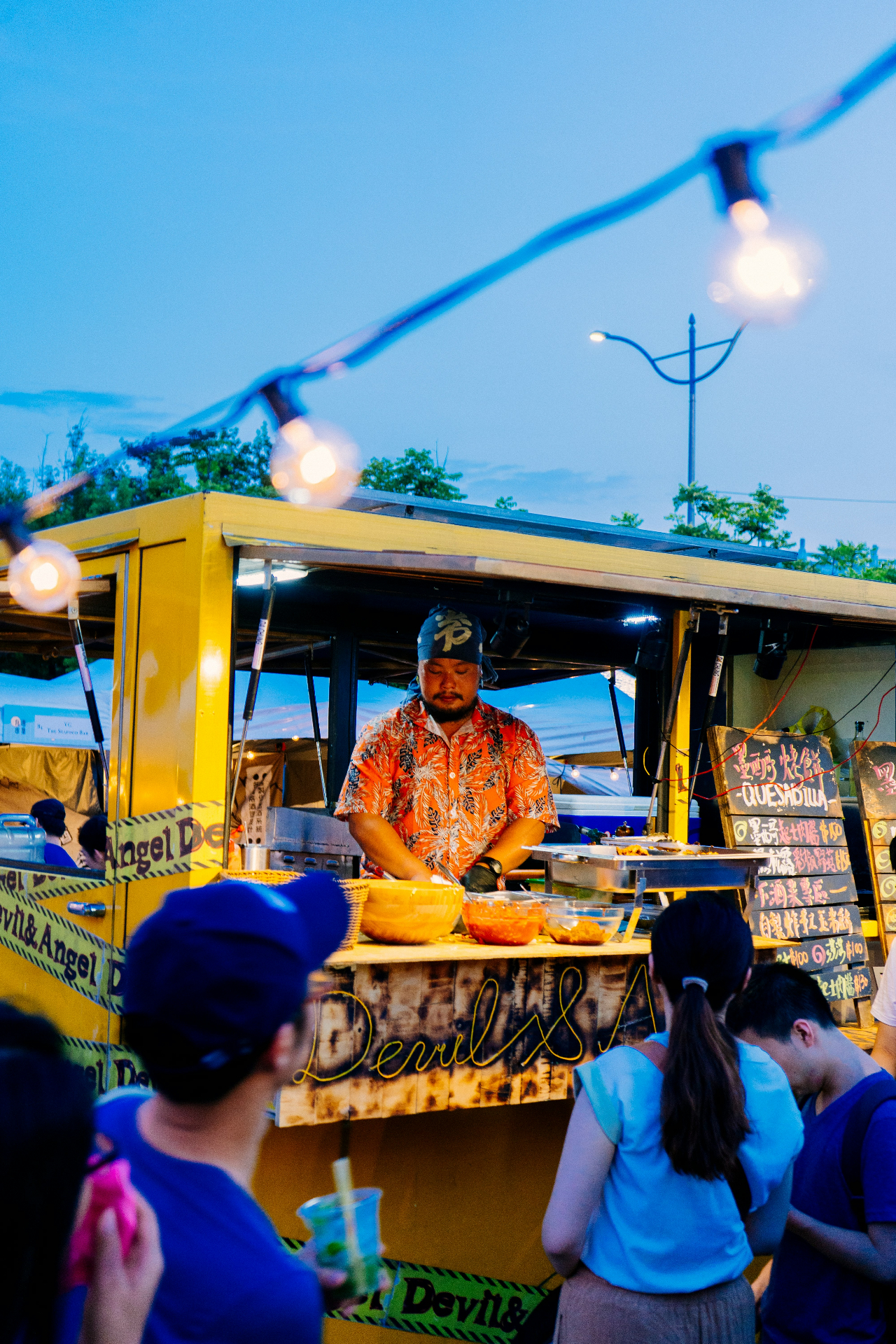Local food makers serving visitors at an outdoor night market